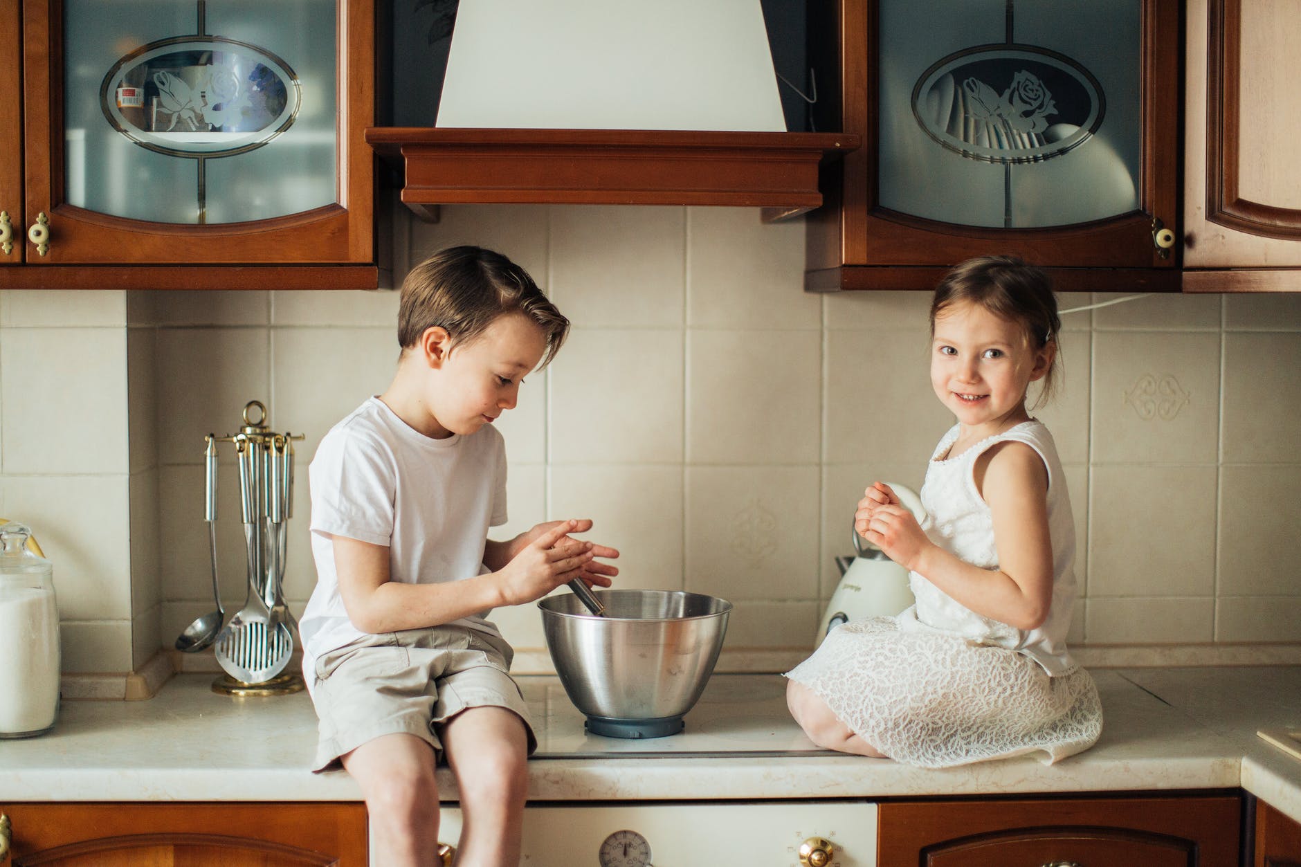photo of kids playing on kitchen counter top
